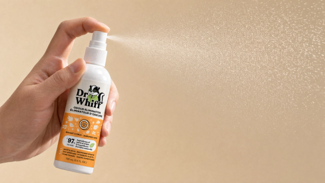 Close-up of a Dr. Whiff spray mist catching the light against a soft neutral background
