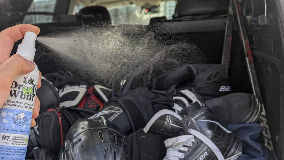 Athletic gym bag with sports gear airing out in a bright, ventilated space