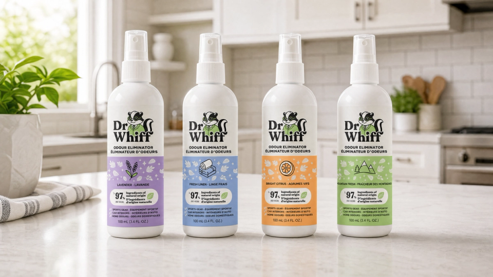 A lineup of naturally derived odor eliminator spray bottles on a bright counter