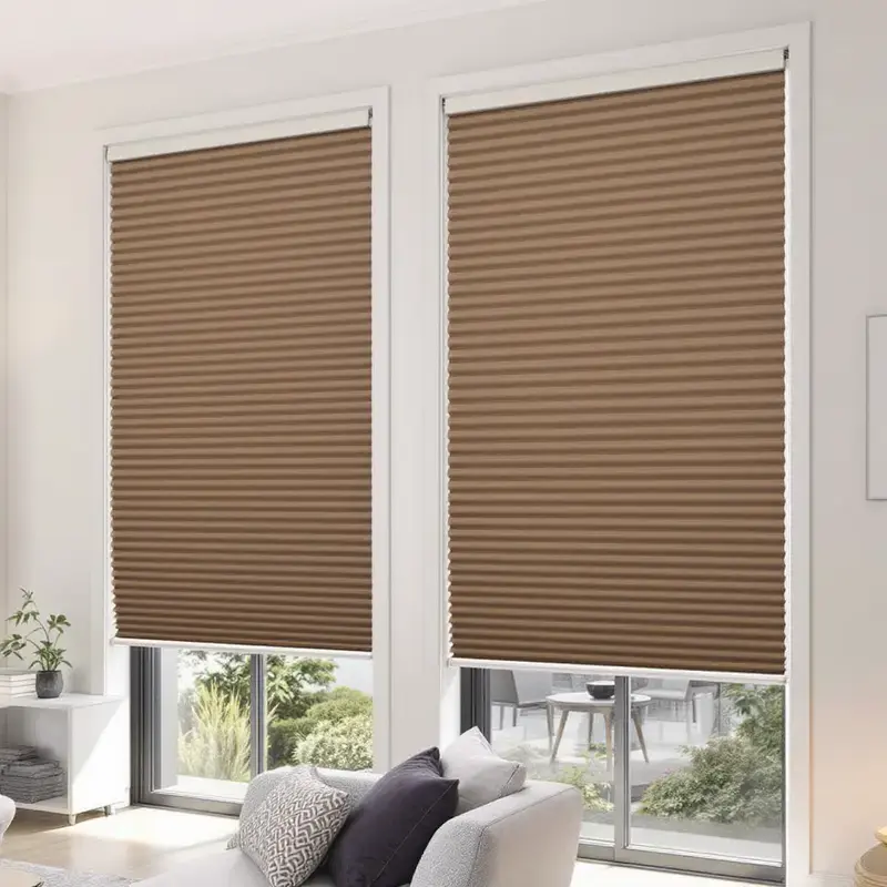 Motorised honeycomb cellular blinds part-raised across tall windows in a modern living room.
