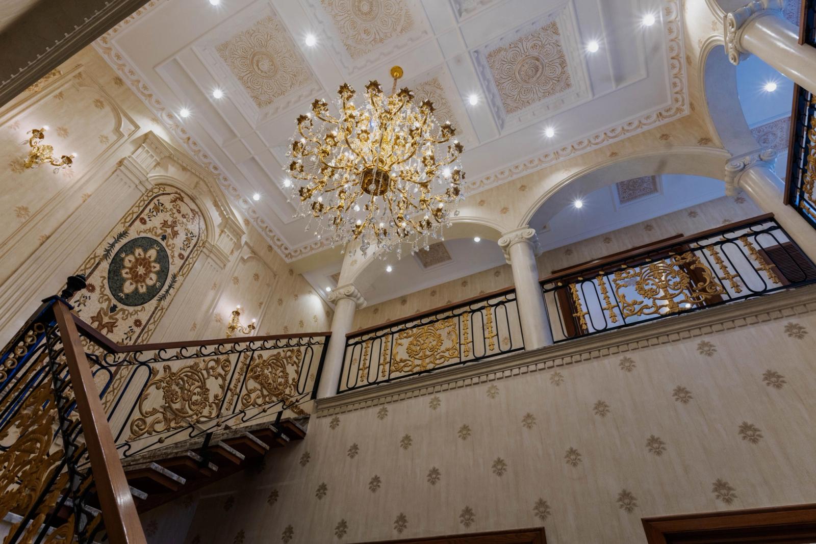 A Mediterranean-revival villa with arched loggias and a tiled roof.