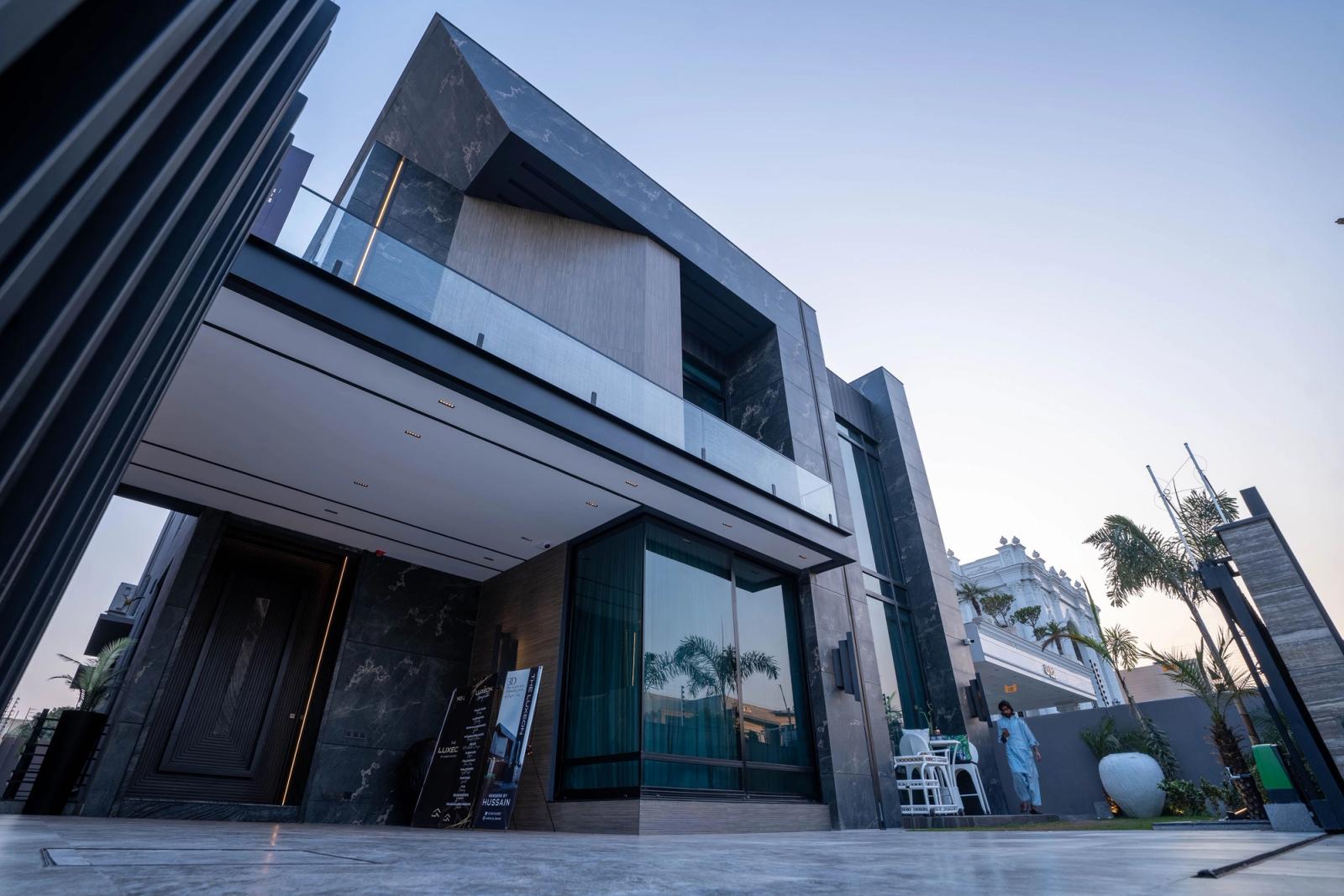 A dark marble-and-glass contemporary villa.