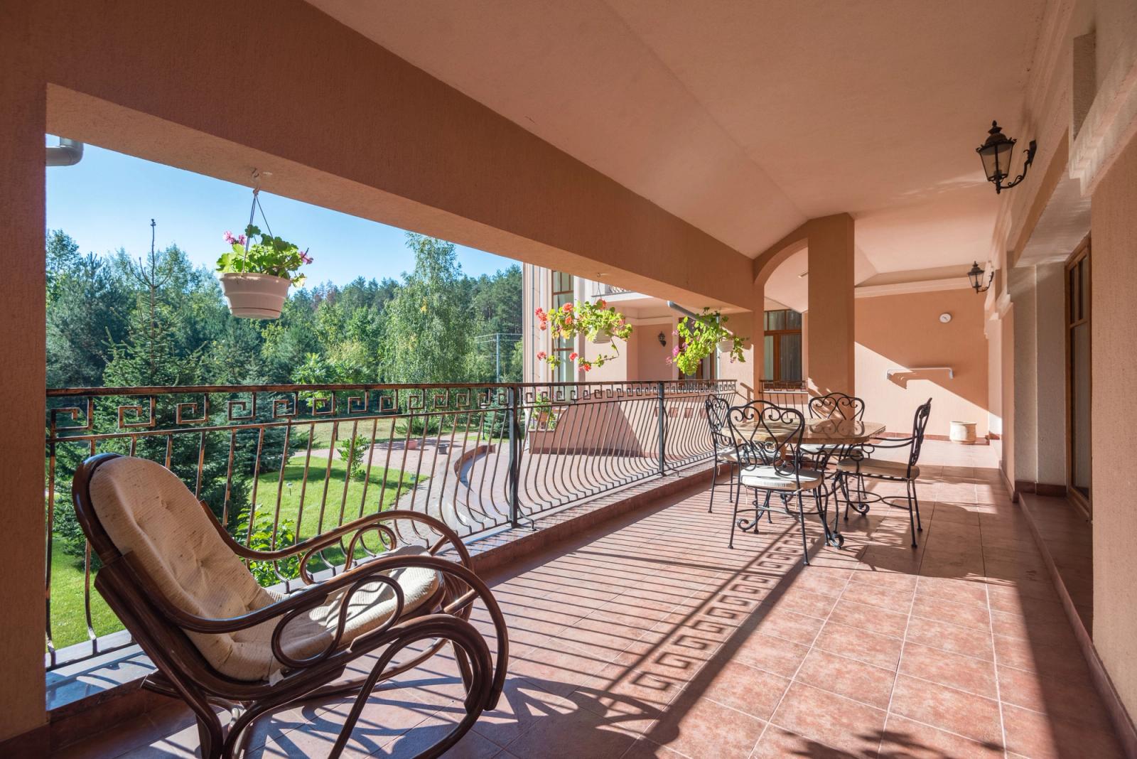 A turreted, chateau-style stucco villa with landscaped grounds.