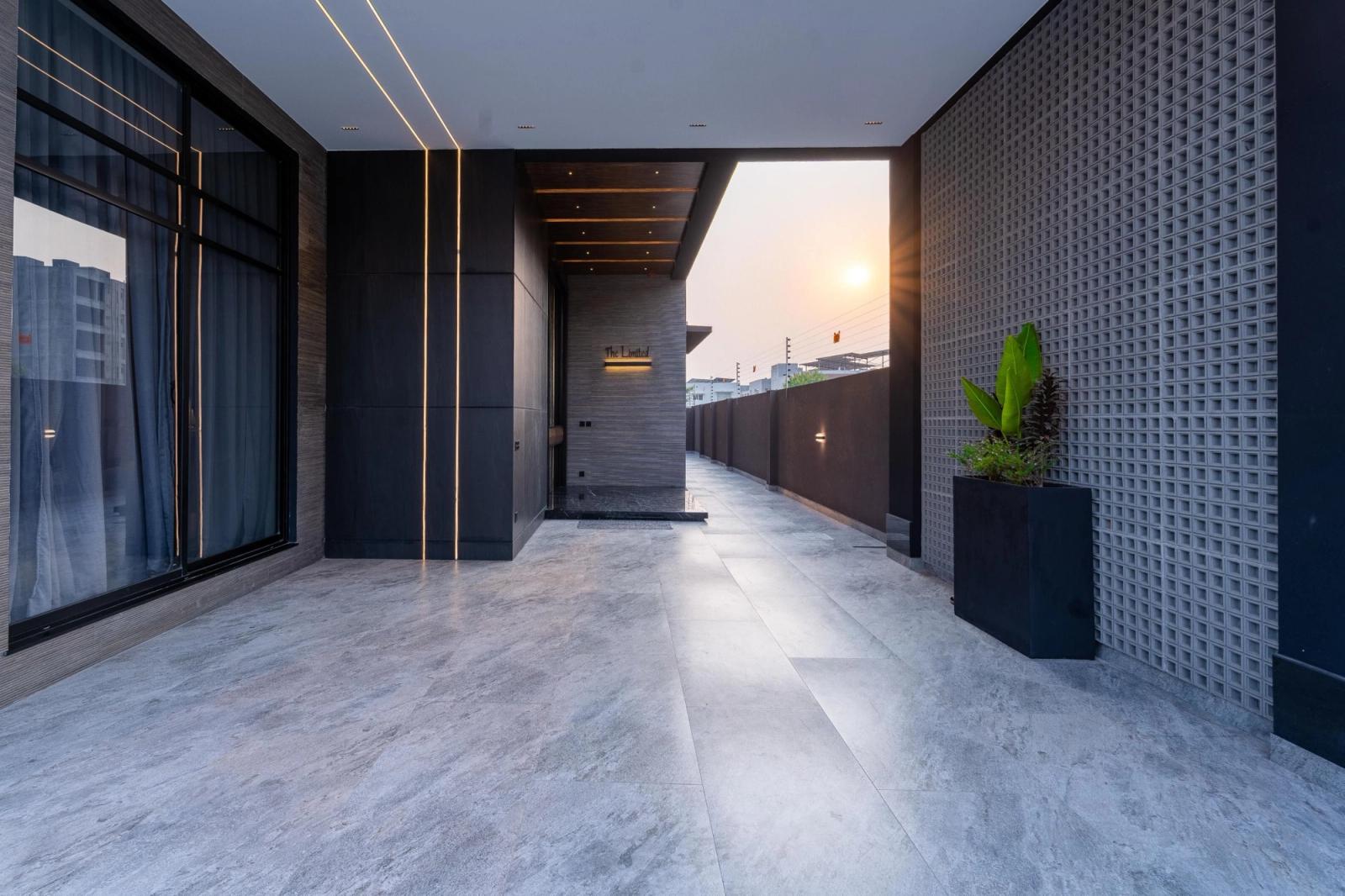 A charcoal-clad contemporary villa with tropical gardens.
