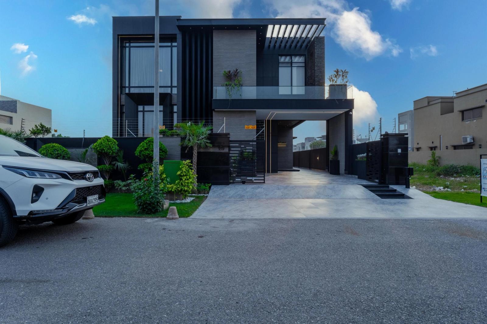 A charcoal-clad contemporary villa with tropical gardens.