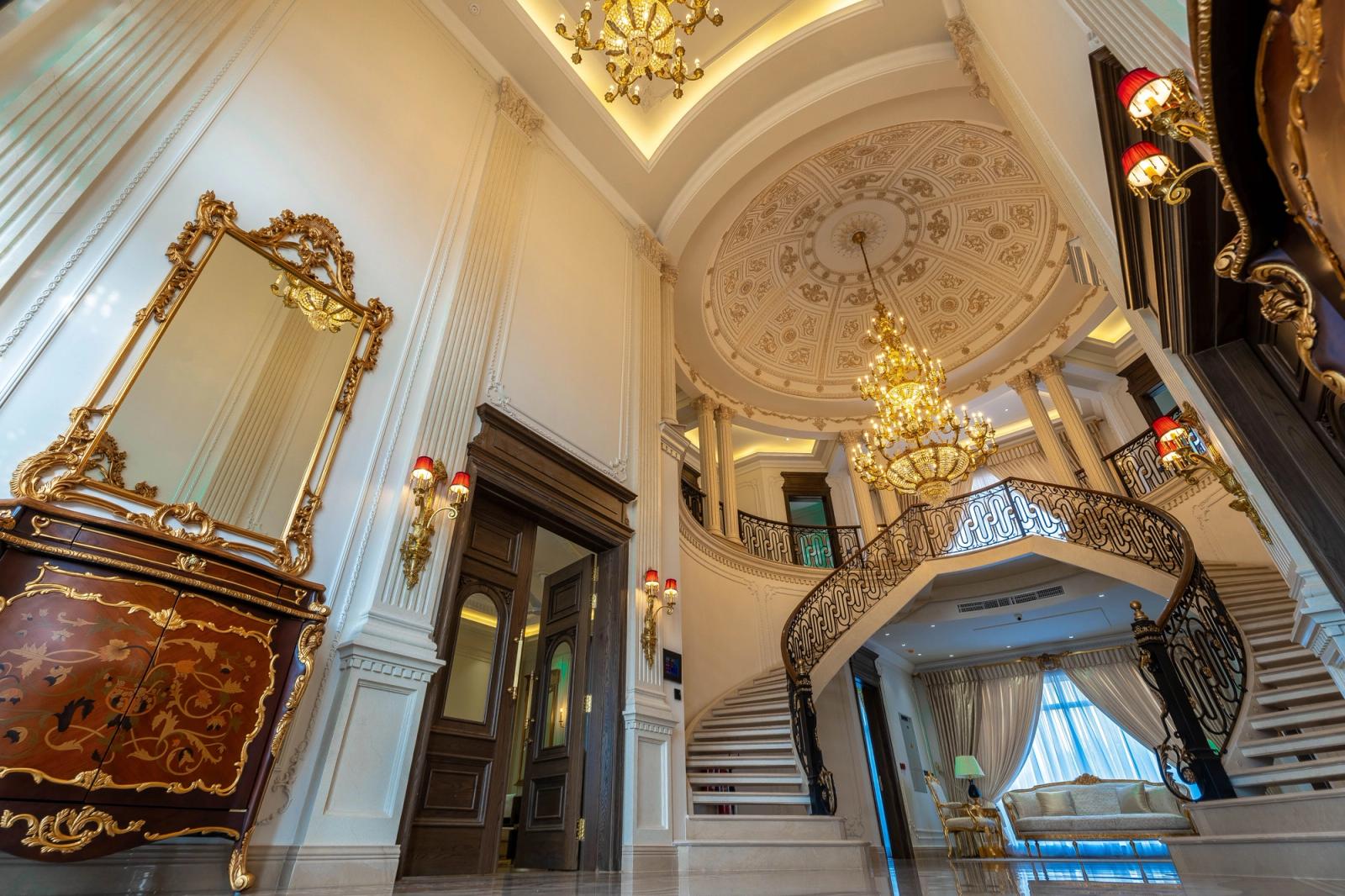 A palatial classical estate with grand, ornate interiors.
