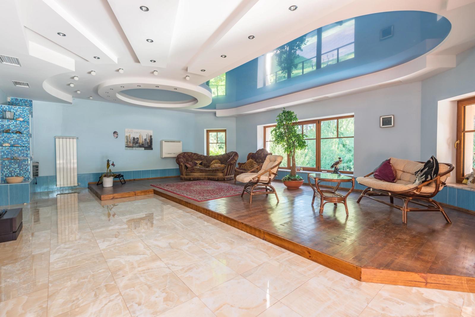 A turreted, chateau-style stucco villa with landscaped grounds.