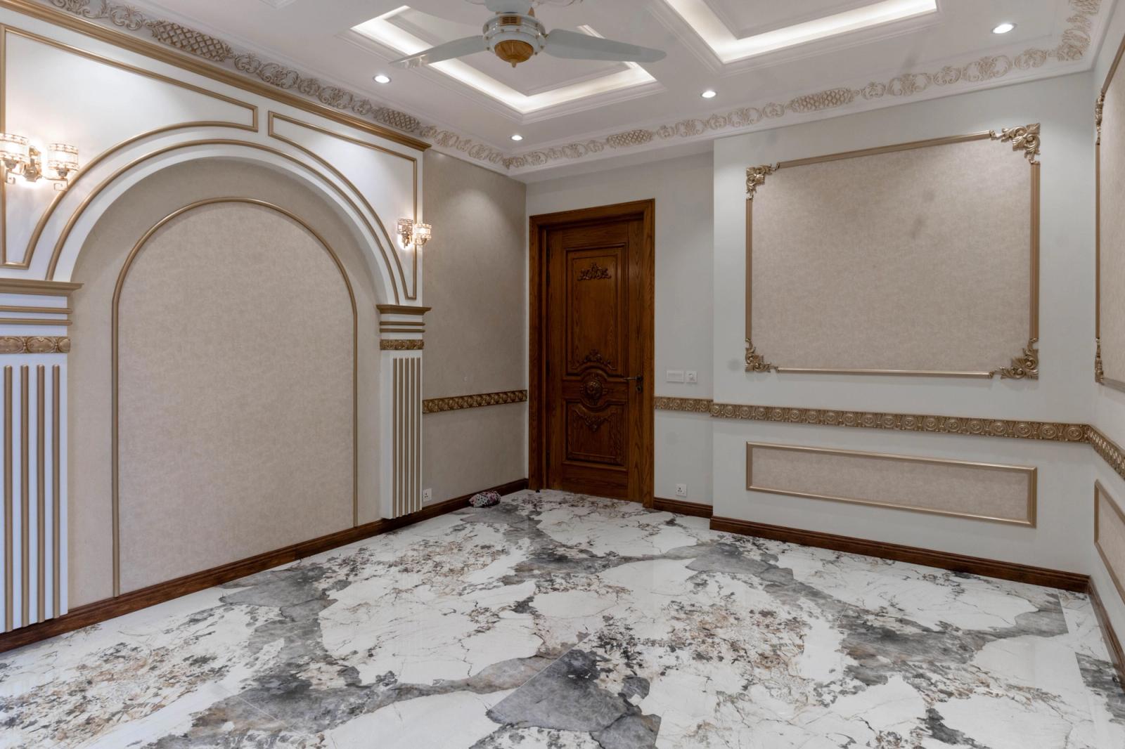 A Mediterranean-revival villa with arched loggias and a tiled roof.