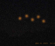 Five amber orbs over the ridge