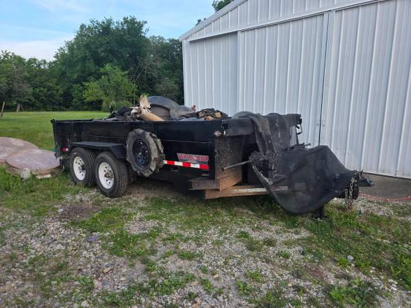 14,000 lb dump trailer with side-loading door, loaded for hauling