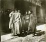 Photograph showing several men standing and talking at the entrance of a shop in the Tiflis bazaar, late 19th century.