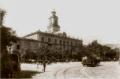 Black and white 19th-century photograph of the Town Council building on Erivan Square in Tiflis, showing a civic tower, horse-drawn carriages, and tram tracks.