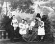 Studio portrait of members of the Bagrationi aristocratic family seated with several children in a photographic studio setting.