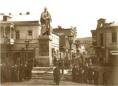 Statue of Count Vorontsov on a pedestal in a public square in Tbilisi surrounded by people and 19th-century buildings.