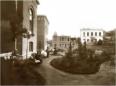 Garden courtyard with pathways, benches, and surrounding institutional buildings at the House of the Indigents in Tbilisi.