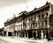 Large multi-storey theatre building with ornate facade and balconies along Glovin Avenue in Tbilisi, with pedestrians on the street.