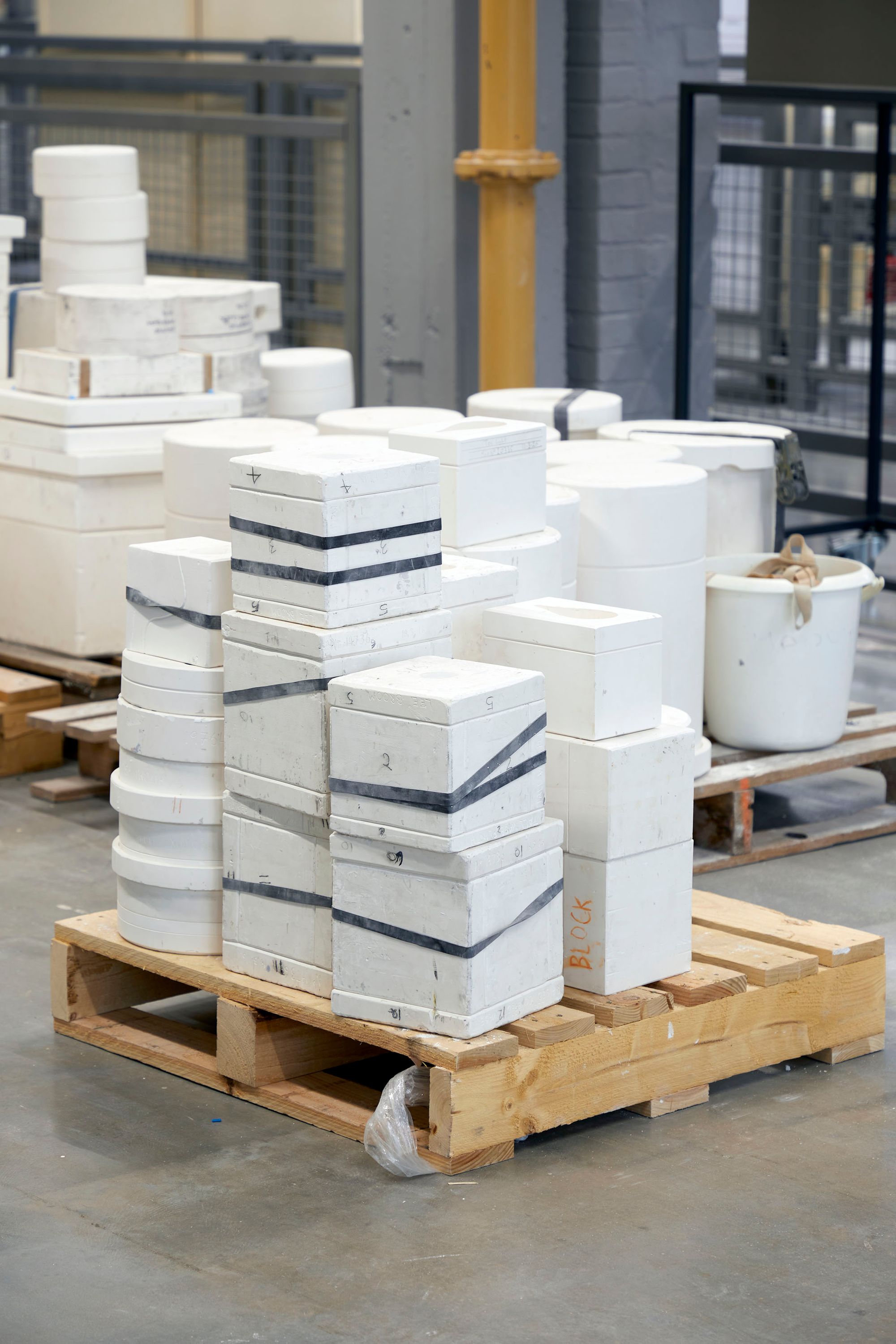Reference image of rubber bands being used to hold casting moulds together on the factory floor.