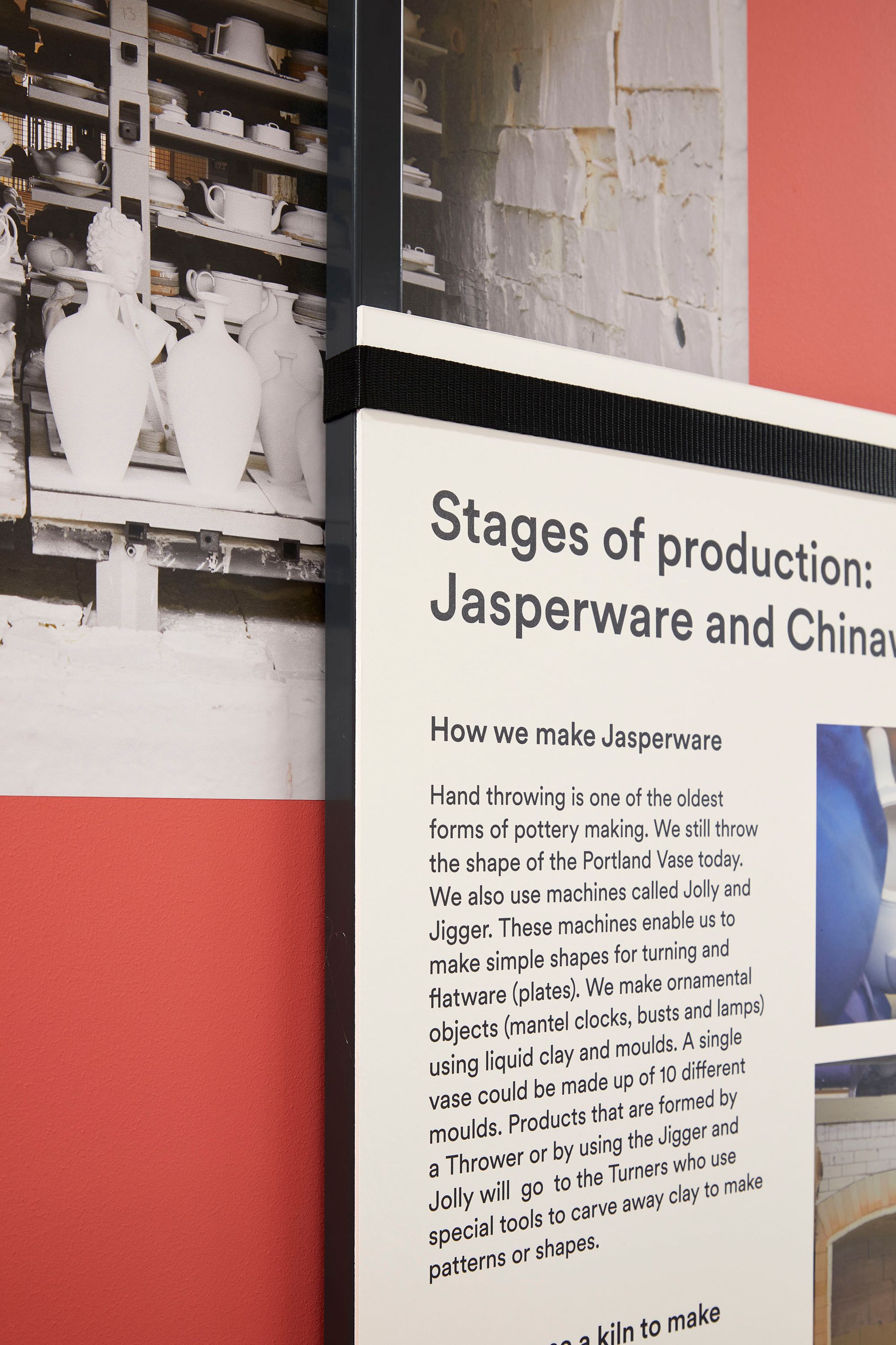 Detail of hanging frame in introductory space, showing text panel held to frame with a ratchet strap