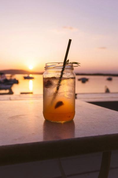 Looking at a beach sunset through a cocktail