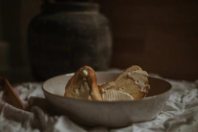 Bowl with butter bread on a table