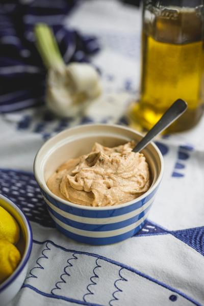 Hummus with olive oil in the background