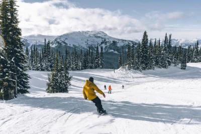 Skiers and snowboarders on enjoying a run on Whistler