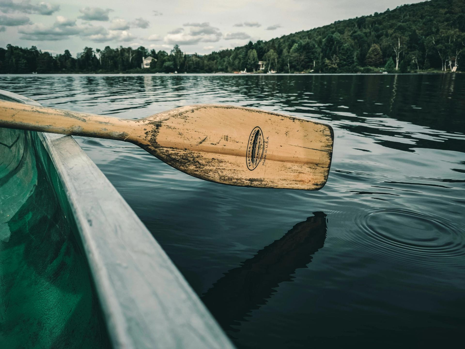 Row boat paddle in a calm lake