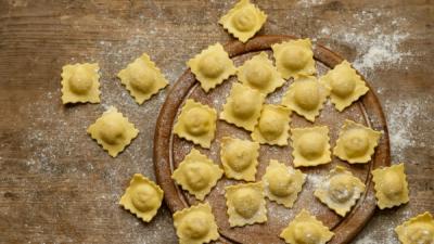 Fresh ravioli on a floured board