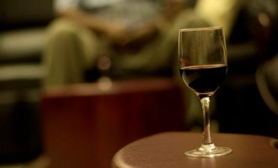 Wine on a low table with people in the background