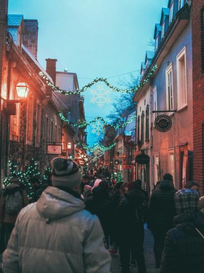 People walking on a festively lit street in winter