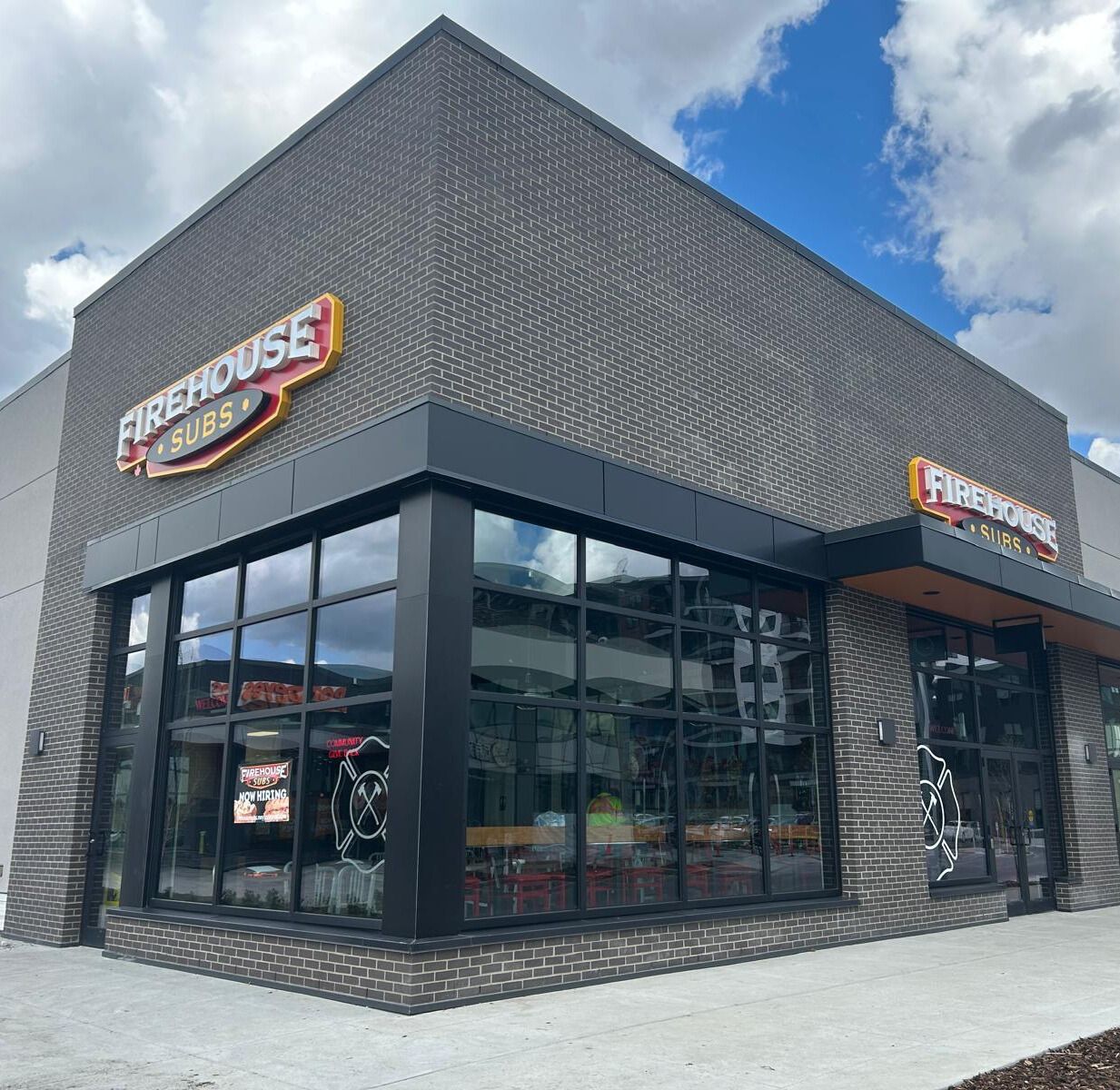 Firehouse Subs counter with menu and community message on the wall.