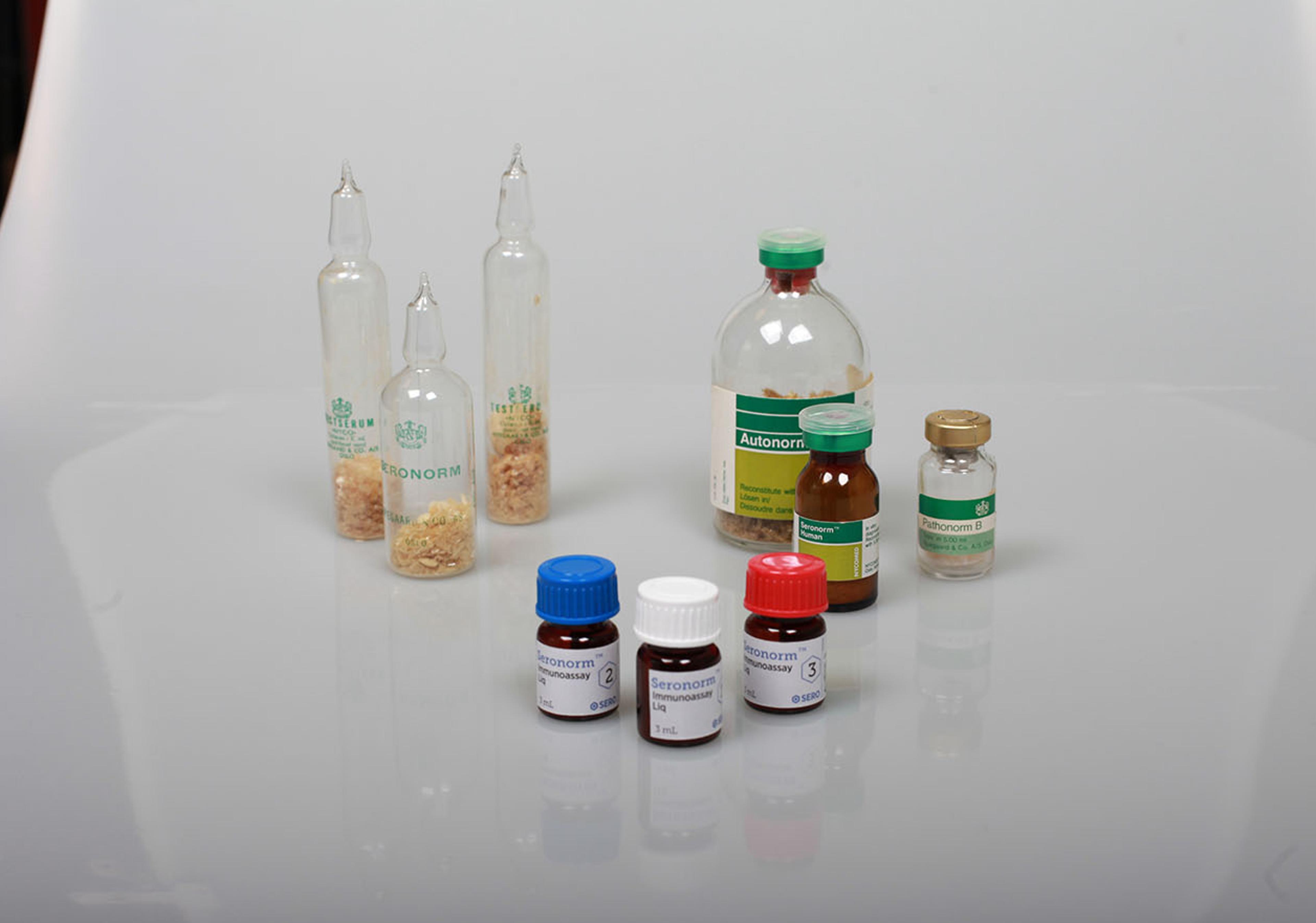 a group of bottles and vials sitting on top of a table .