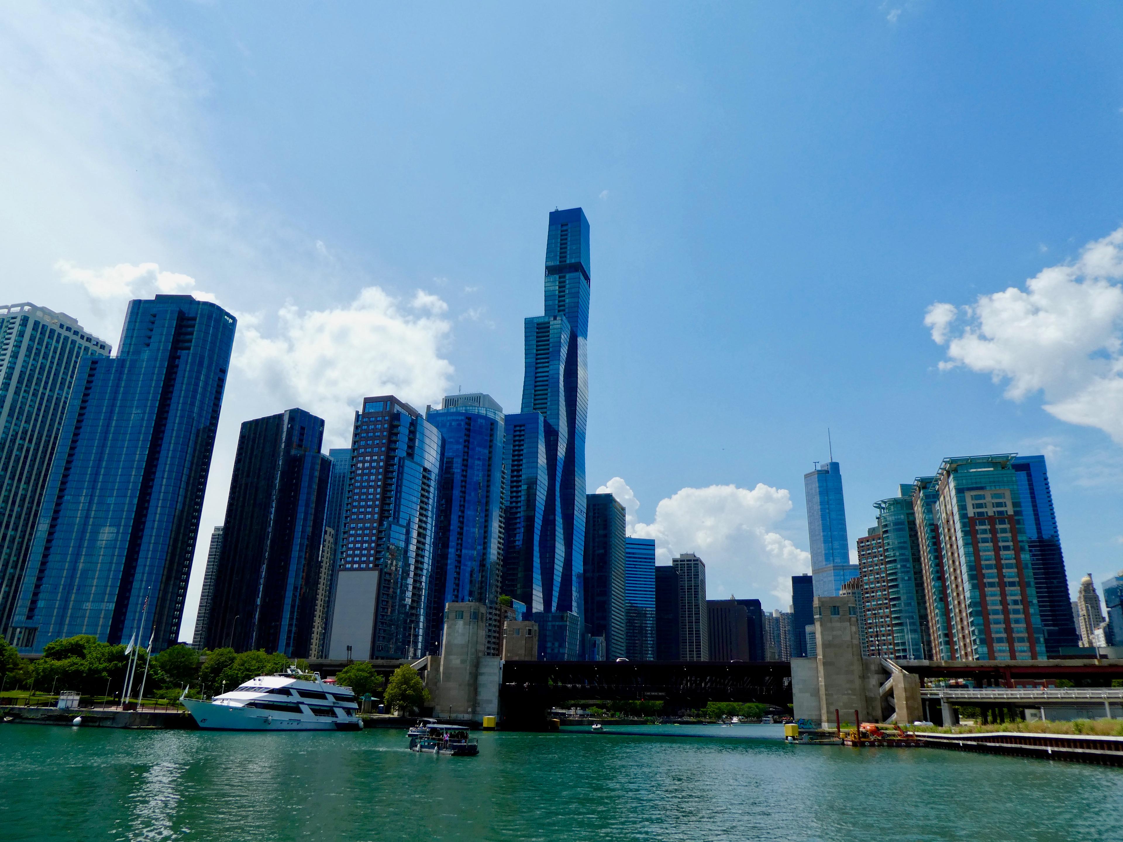 a boat is floating in the water in front of a city skyline .