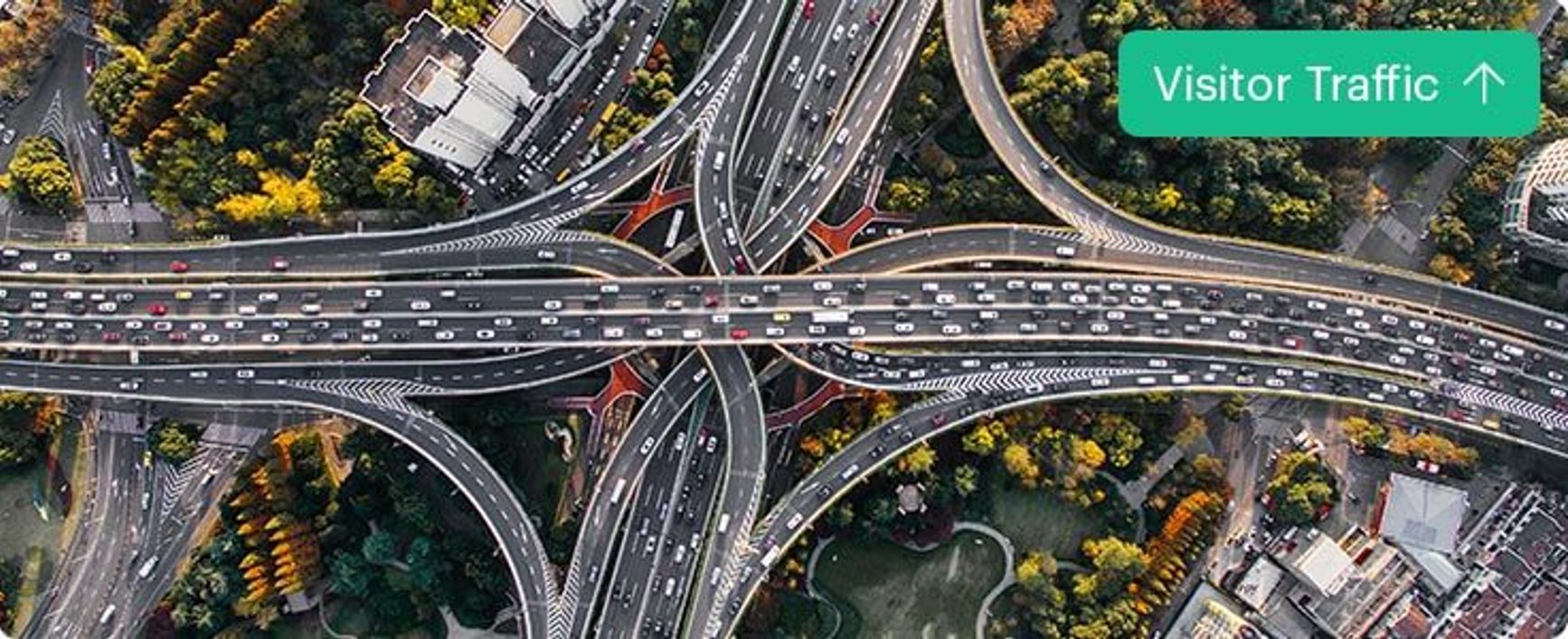 A picture of busy traffic on the road with the text "Vistor Traffic" and an arrow pointing up.
