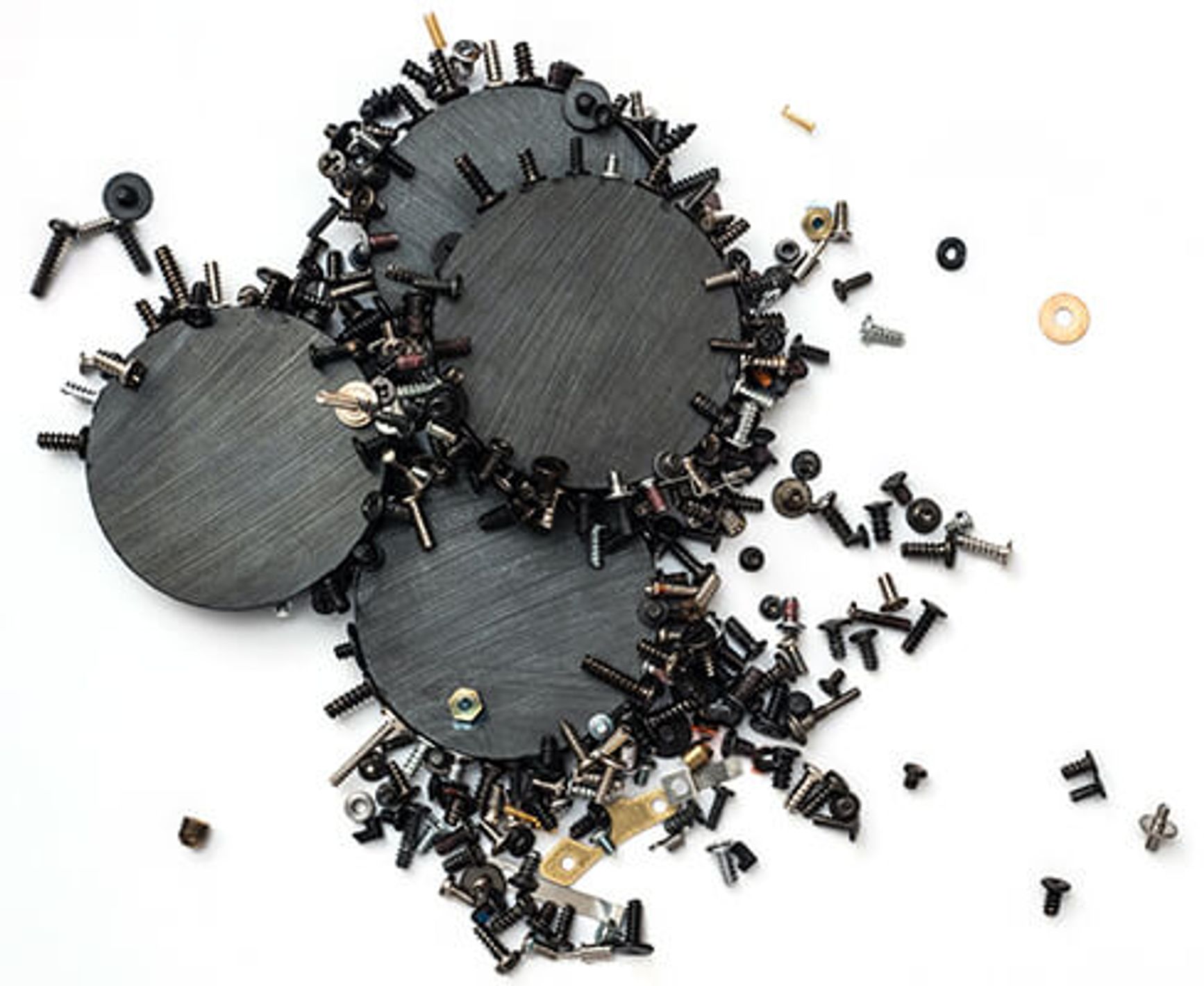 A photo of three magnets that have many screws, bolts and washers stuck to them.