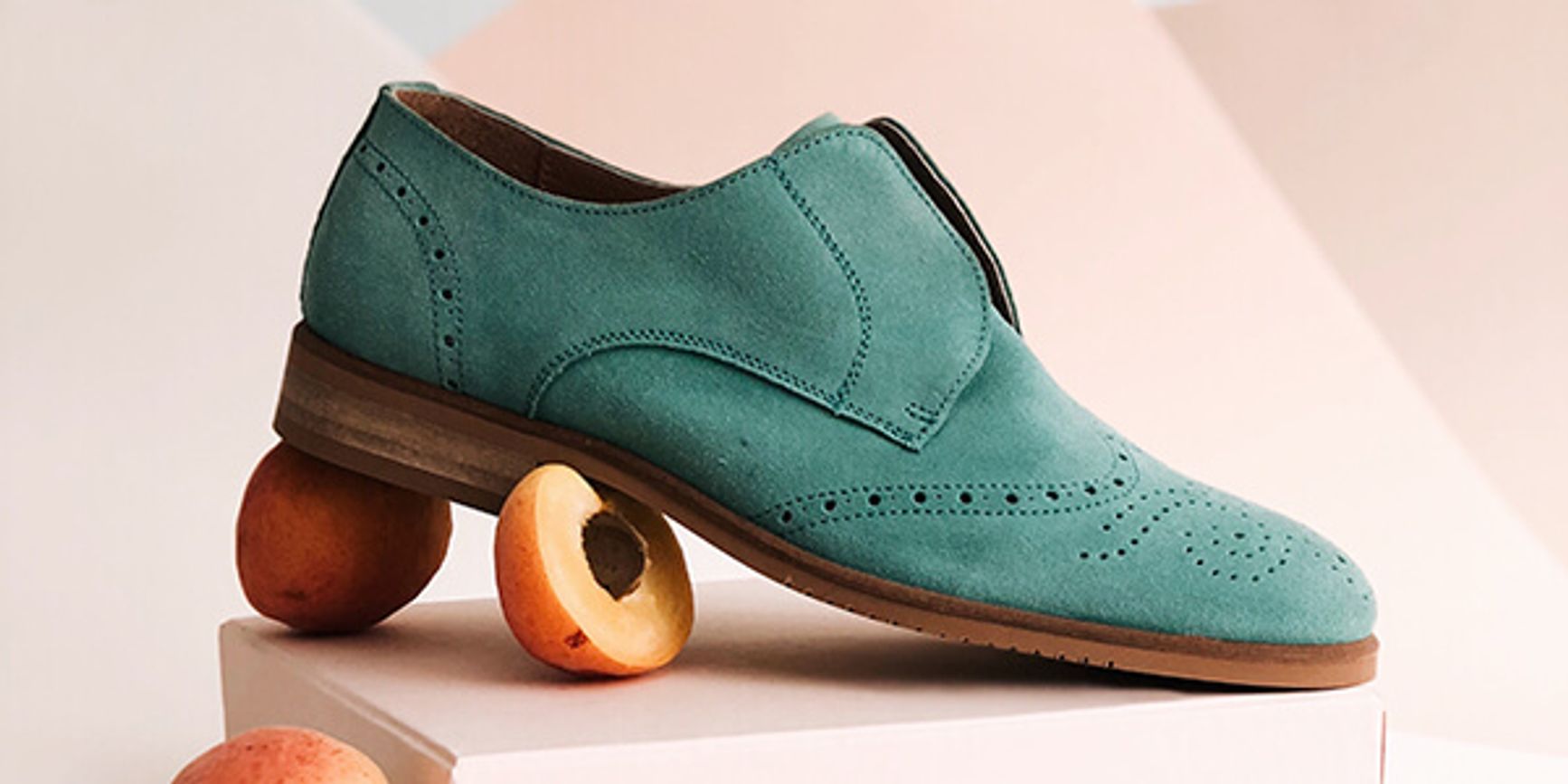 A beautifully composed image of a leather shoe with props and an aesthetic background.