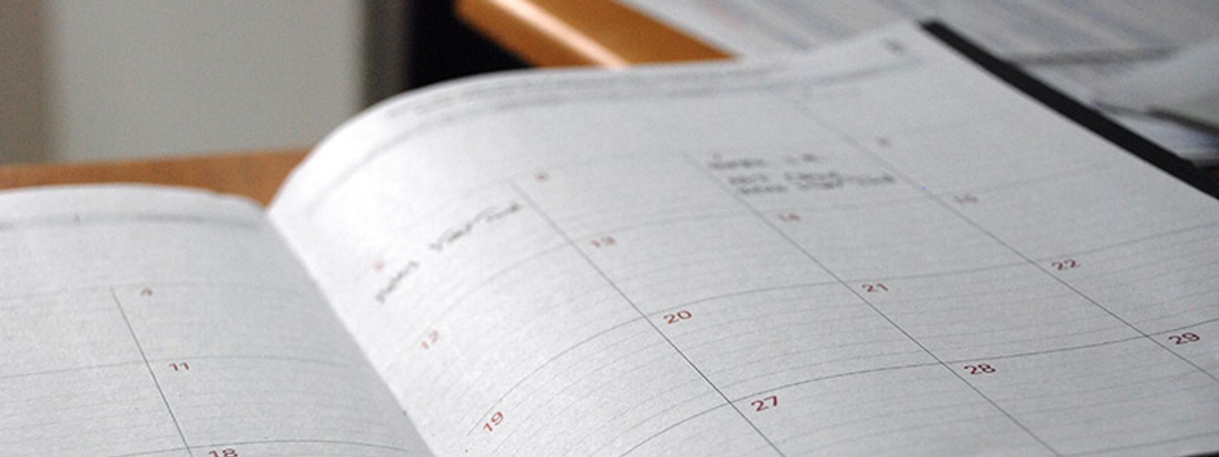 A photo of someone's paper planner, open to a calendar.