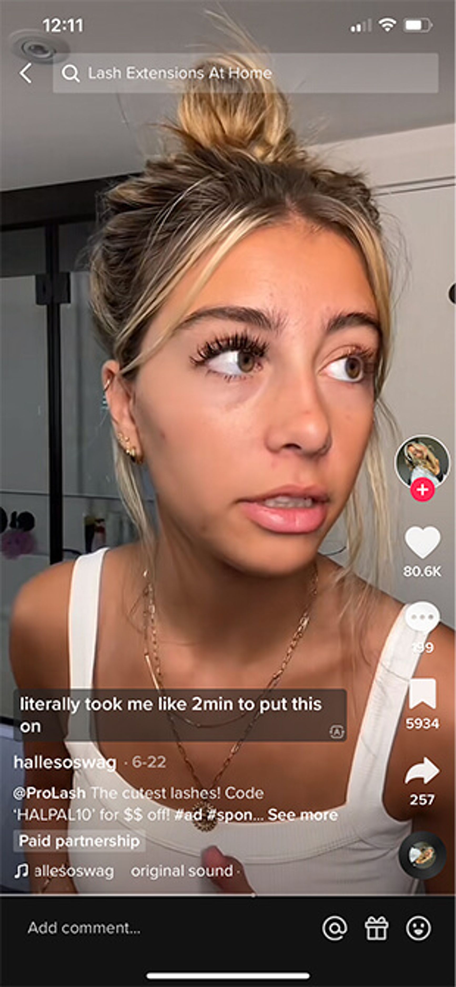 A screenshot of an ad on TikTok where a woman is showing off artificial eyelashes applied to one of her eyes. The caption reads "literally took me like 2min to put this on"