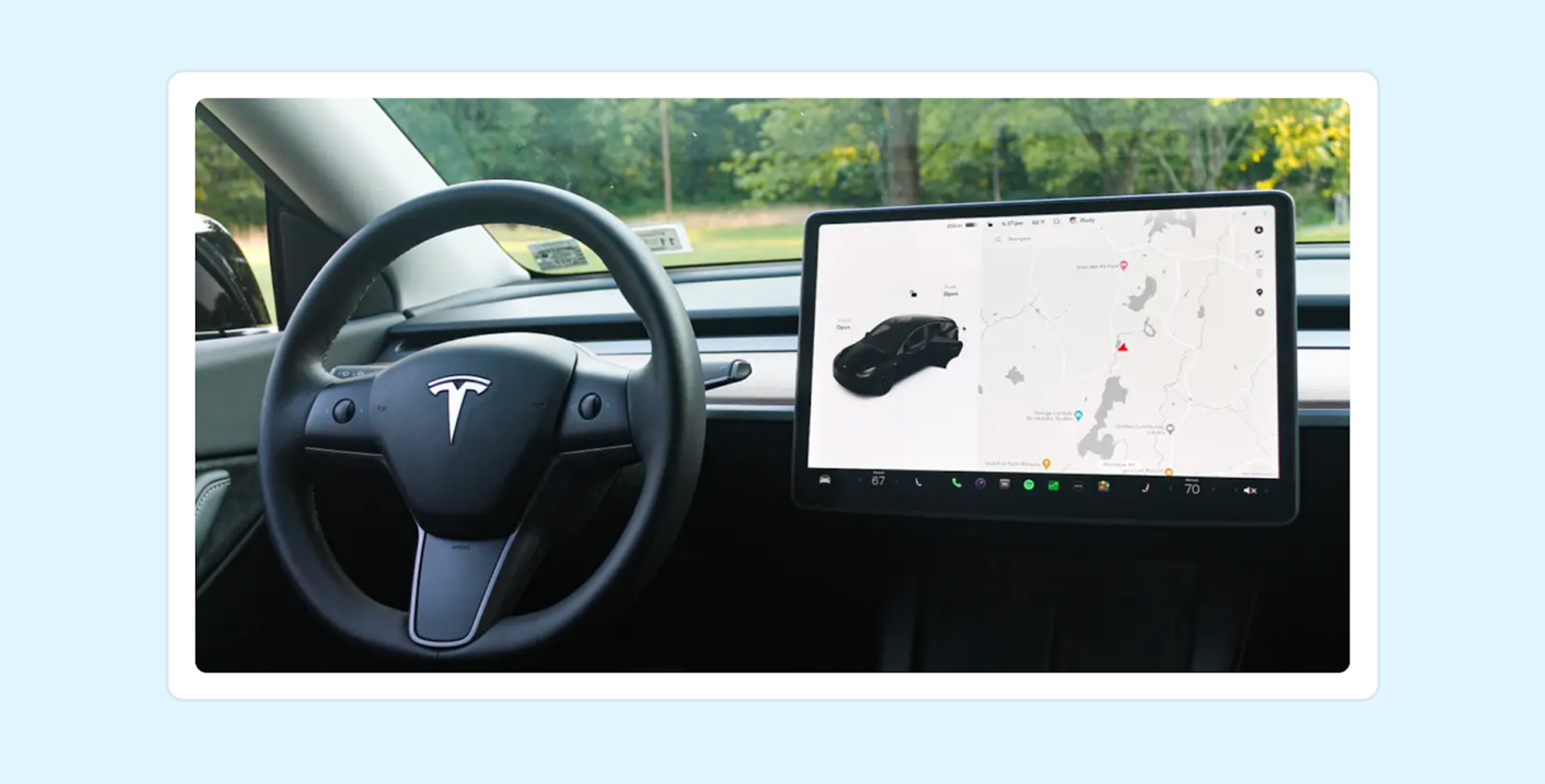 A picture of the steering wheel and autopilot inside of a Tesla
