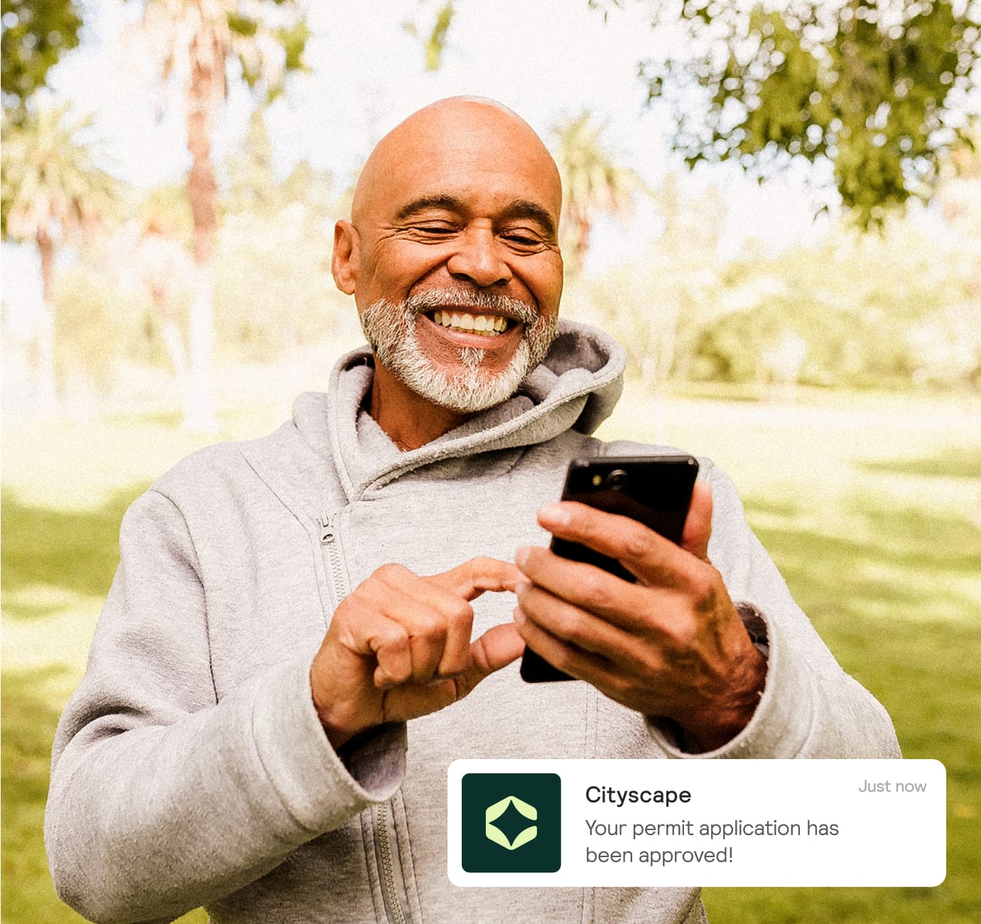 Photo of man viewing cityscape application on his phone