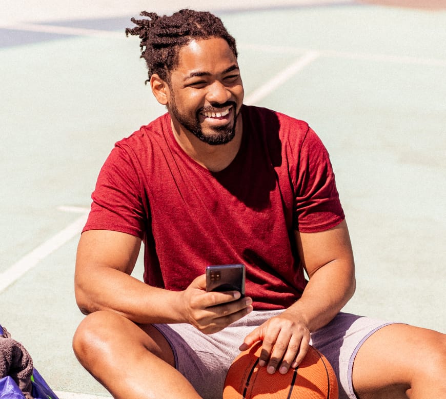 Man texting on basketball court