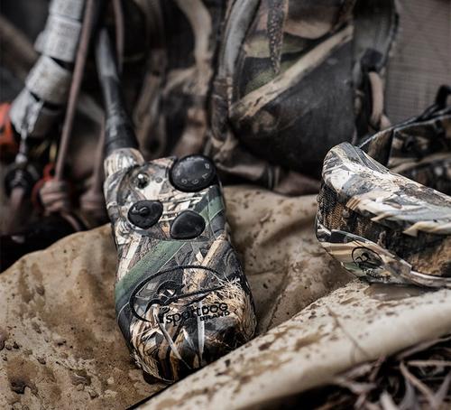 pile of waterfowl gear. focus on camouflaged e-collar system