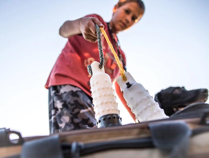 Young boy pulling dummies out of gear bag
