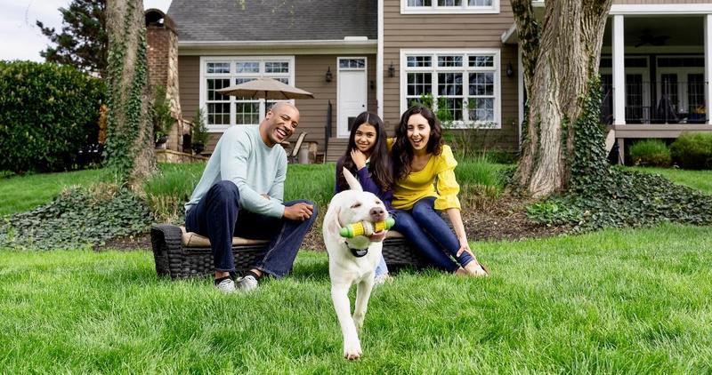 Family in backyard with dog