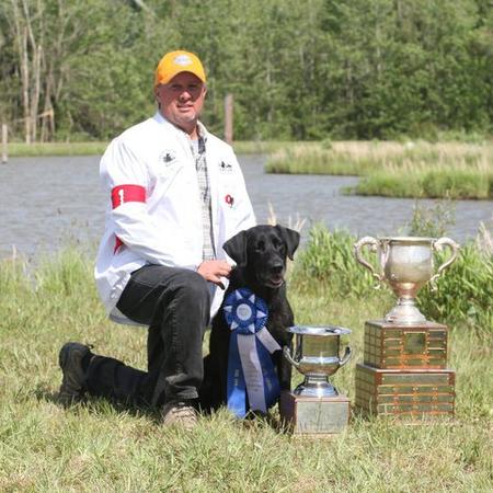 man and dog and trophies
