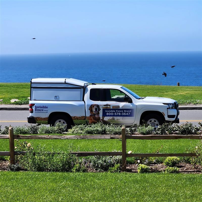 invisible fence truck parked along California coast with ocean in background