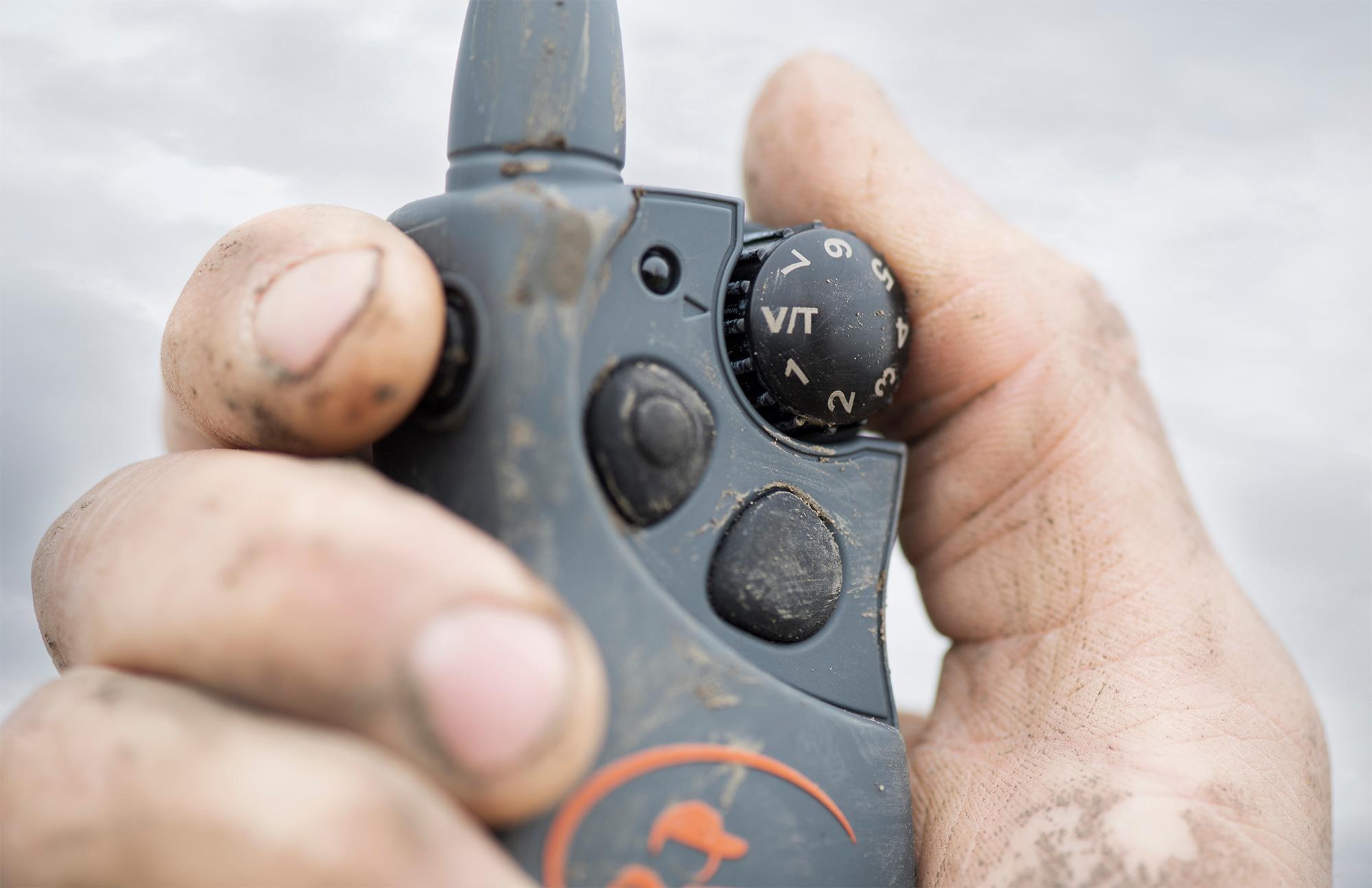 Close up of e-collar remote being held in hand