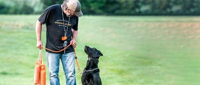 man and dog with training accessories