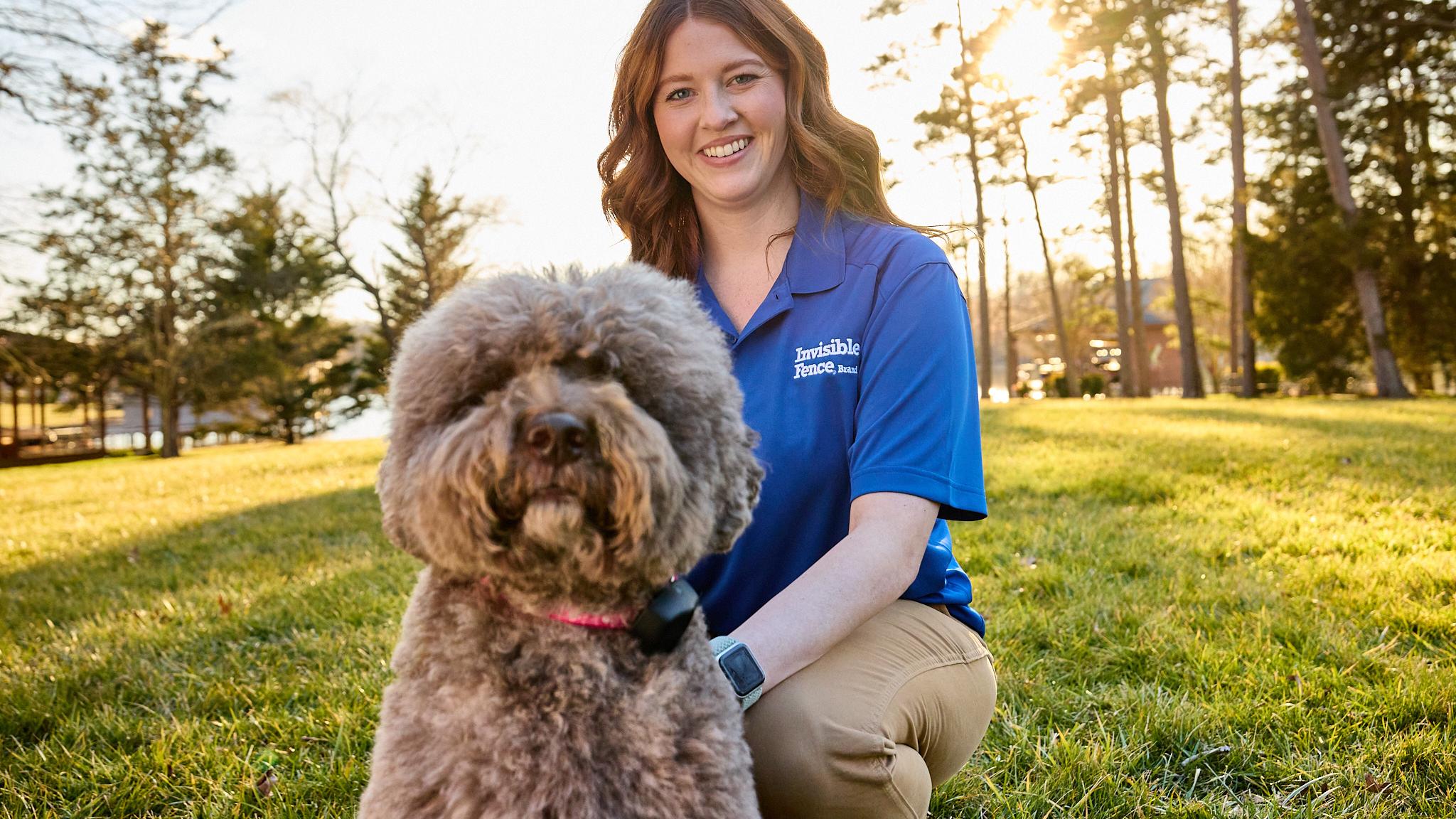 Lagotto Romagnolo dog wearing an invisible fence collar with trainer enjoying the yard