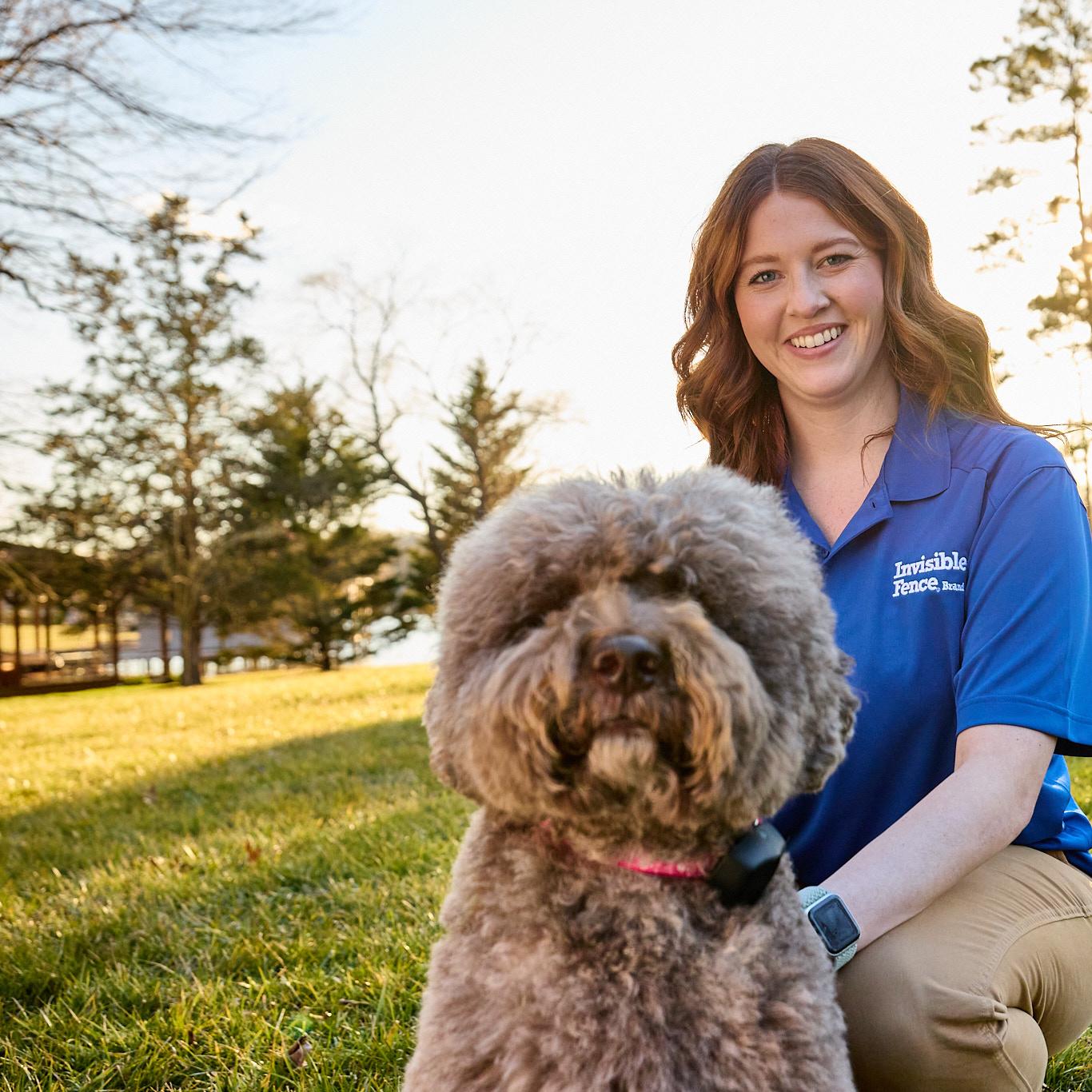 Lagotto Romagnolo dog wearing an invisible fence collar with trainer enjoying the yard